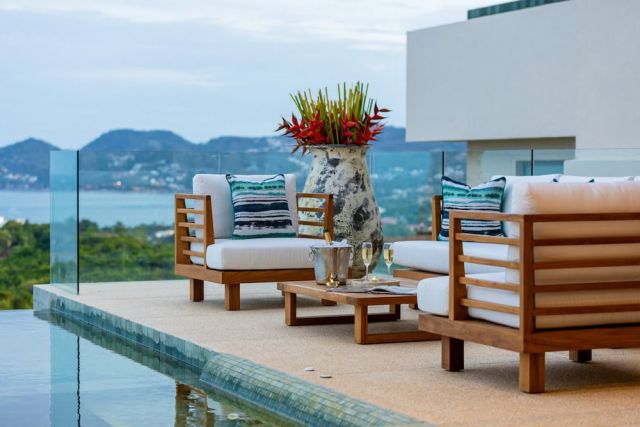 Bespoke luxury outdoor furniture on a Koh Samui villa terrace overlooking the pool
